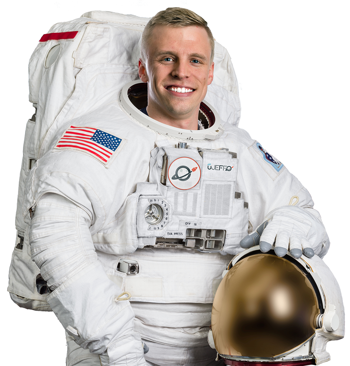 A man in an astronaut suit, smiling with his helmet off.